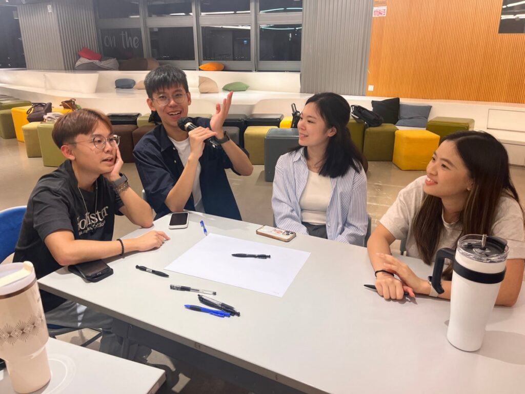 A team discussing community problems at the Young Tinker workshop