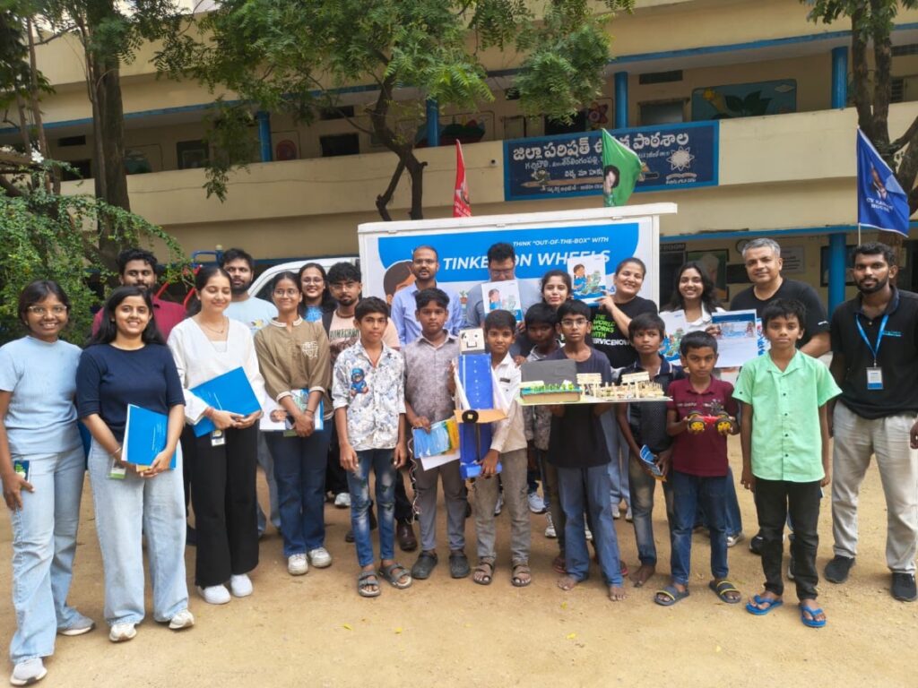 ServiceNow volunteers and students group photo with the Tinker on Wheels van